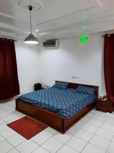 Giường trong phòng chung tại Villa AV Lomé