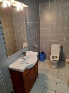 a bathroom with a sink and a toilet at Villa AV Lomé in Lomé