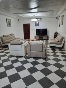 un soggiorno con divani e pavimento a scacchi di Villa AV Lomé a Lomé