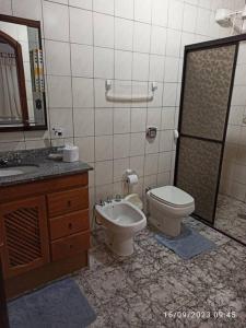 a bathroom with a toilet and a bidet and a sink at Casa de Campo em Serra da Cantareira in Mairiporã