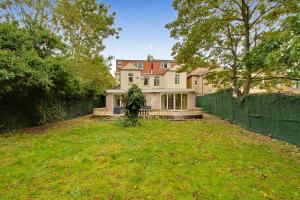 a large house with a fence in a yard at Noel Oasis : London Retreat in London