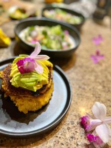 a piece of cake with flowers on top on a table at Volcano Eco Retreat by Heart Core Hotels - Adults Only in Mountain View