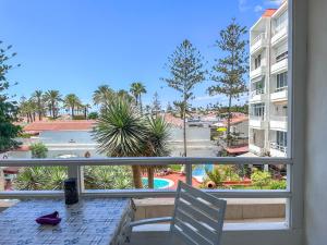 a view from a balcony with a table and a chair at Yumbo Sunset Suite Tanife - Next to Yumbo in Playa del Ingles