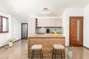 a kitchen with a counter and two stools at Villa Miromar in Pula