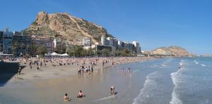 a group of people on a beach with a mountain at R-1-Комната в квартире для 2 человек -Alicante centro in Alicante