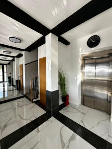 a lobby with black and white floors and a elevator at La Vista Luxury Villa in Ohrid