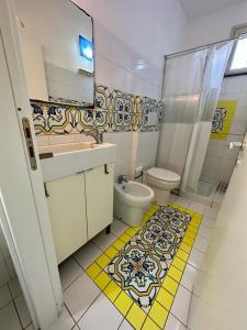 a bathroom with a toilet and a sink and a shower at B&B Acireale - Il Cavalluccio Marino Fronte Mare in Acireale