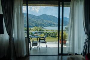 a room with a table and chairs and a large window at Jade City Hotel in Pokhara