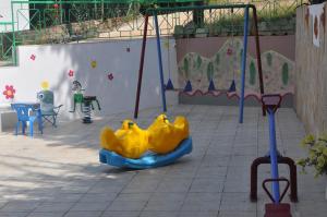 a playground with a slide in a park at Studios Ifigenia in Skala Potamias