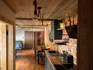 a kitchen and dining room with a brick wall at Apartmany FABRIK in Vysoká nad Kysucou