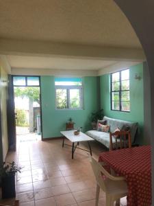 a living room with a couch and a table at Joy's Apartment in Roseau