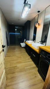 a bathroom with two sinks and a toilet at Apartmany FABRIK in Vysoká nad Kysucou