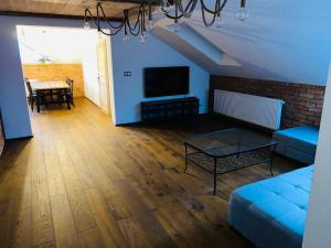 a living room with a couch and a table at Apartmany FABRIK in Vysoká nad Kysucou