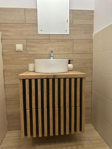 a bathroom with a sink and a mirror at Apartament Oksford 1 in Okszów +10 photos