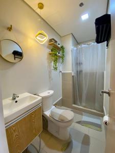 a bathroom with a toilet and a sink and a shower at Japandi Zen: Victoria's Haven (SMDC Cheer) in Marilao