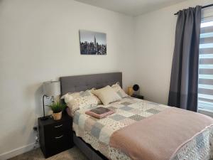 a bedroom with a bed and a picture on the wall at Good Fortune Residence, Ottawa in Ottawa
