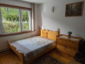 a bedroom with a bed and a window at Апартамент Извор 6 in Smolyan