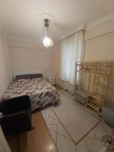 1 dormitorio con 1 cama y 1 silla en Comfy home in Nisantasi, en Estambul