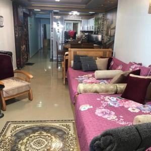 a living room with two beds and a couch at شقه فاخره على الكورنيش in Alexandria
