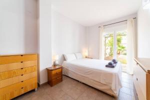 a white bedroom with a bed and a window at Trendy Homes Toyo Golf in Almería