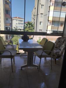 a table and chairs in a room with a window at Yalova in Çiftlikköy