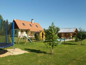a yard with a house and a playground at Chalupa Les Království 