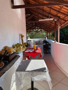 a table with a plate of food on a balcony at Pousada Núcleo da Serra in Serra do Cipo