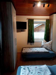 a small room with a bed and a window at Appartement Kieler in Haus im Ennstal