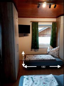 a small bedroom with a bed and a window at Appartement Kieler in Haus im Ennstal