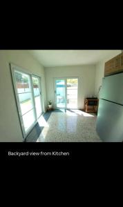 a kitchen with a refrigerator and sliding glass doors at Boater House PR in Salinas