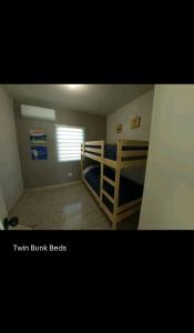 a small bedroom with a bunk bed and a window at Boater House PR in Salinas