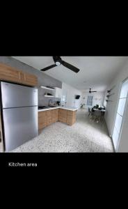 a kitchen with a refrigerator and a table in it at Boater House PR in Salinas