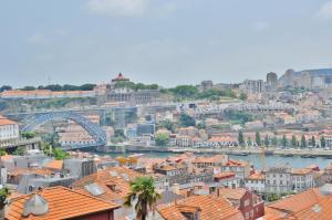 a city street with a large building and a clock tower at PipaD'oro by YoursPorto in Porto