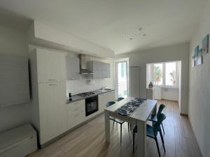 a kitchen with a table and chairs in a room at Casa A-mare in Varazze