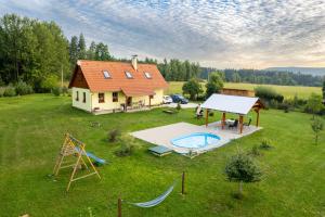 an aerial view of a house with a pool and a playground at Chalupa Les Království 