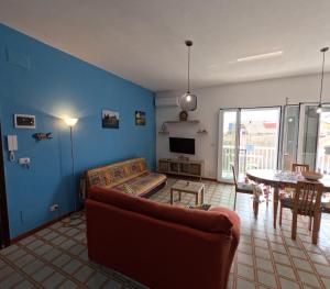 a living room with a couch and a table at Andrea's Home in Marina di Modica