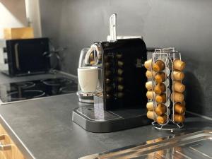 a kitchen counter with a coffee maker on a counter top at Apart54-Modern Design I Garden with Terrace I Smart TV I Free Parking I Free WiFi in Hamm +11 photos