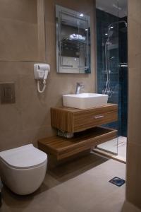 a bathroom with a sink and a toilet and a shower at Saraya locanda in Al Salt