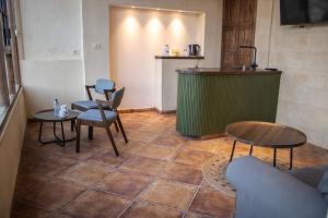 a room with a table and chairs and a counter at Saraya locanda in Al Salt