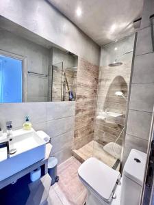 a bathroom with a toilet and a sink and a shower at Peaceful 3 Bedroom apartment in Athens center in Athens