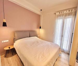 a bedroom with a bed and a table and a window at Peaceful 3 Bedroom apartment in Athens center in Athens