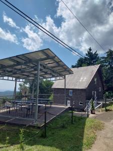 a bus stop in front of a barn at Mátrai5Vendégház in Galyatető