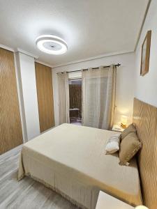 a bedroom with a large bed and a window at Casa Dorsya - near the beach, Torrevieja, Spain in Torrevieja +34 photos