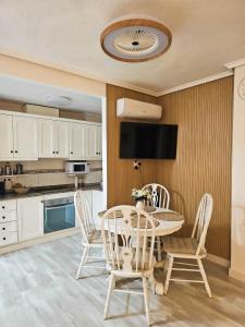 a dining room with a table and chairs in a kitchen at Casa Dorsya - near the beach, Torrevieja, Spain in Torrevieja