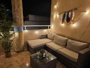 a living room with a couch and a table at Casa Dorsya - near the beach, Torrevieja, Spain in Torrevieja