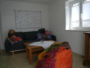 a living room with a couch and a table at Ferienwohnung Dada in Oettingen in Bayern