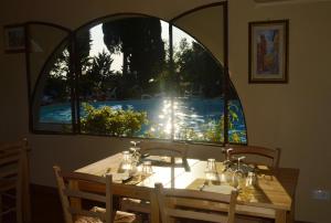 a dining room table with a large window at Camping Village Panoramico Fiesole in Fiesole