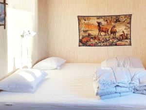 a bedroom with a bed with a picture on the wall at Holiday home RIMFORSA VI in Rimforsa