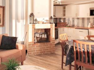 a kitchen with a living room with a fireplace at Holiday home RIMFORSA VI in Rimforsa