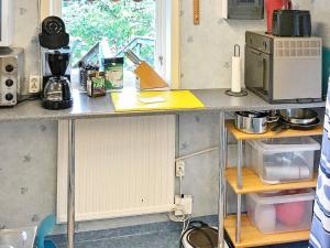eine Küche mit einer Arbeitsplatte und einer Mikrowelle in der Unterkunft Holiday home TYRESÖ V in Tyresö